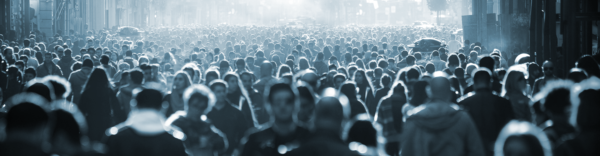 thousands of people walking through a city street